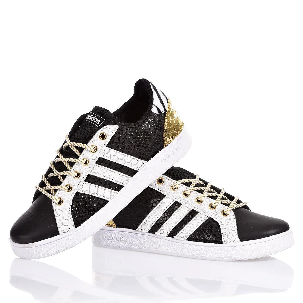 Sneakers customizzate nere e bianche con dettagli dorati e lacci intrecciati